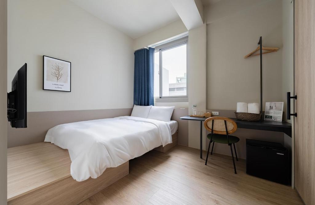Postel nebo postele na pokoji v ubytování Timios Inn 提米好旅