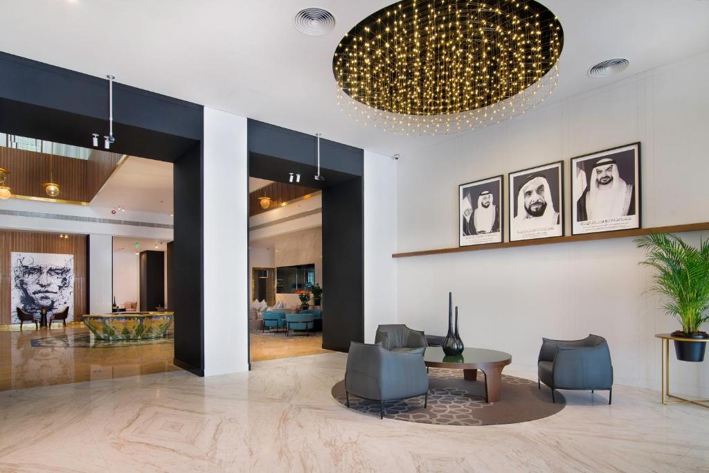 a lobby with a table and chairs and a living room at Le Meridien Abu Dhabi in Abu Dhabi