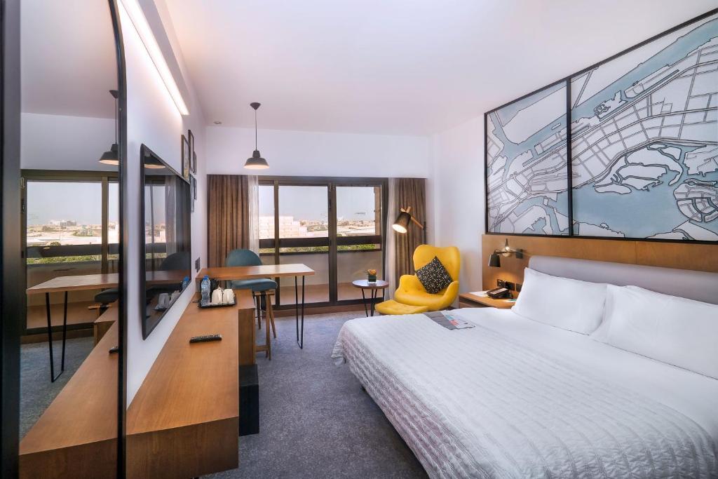 a hotel room with a bed and a desk at Le Meridien Abu Dhabi in Abu Dhabi