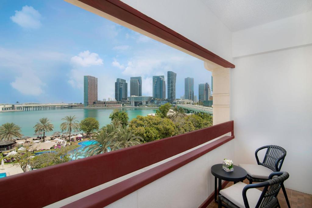a balcony with a view of the city at Le Meridien Abu Dhabi in Abu Dhabi