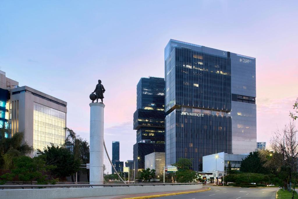 una estatua frente a una ciudad con edificios altos en JW Marriott Hotel Guadalajara en Guadalajara