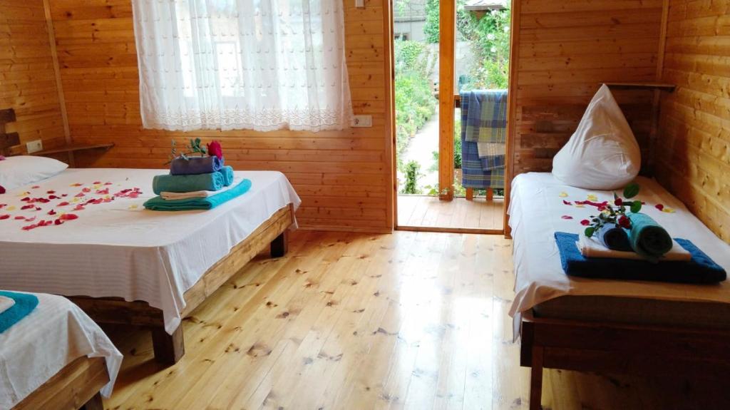 a room with two beds in a log cabin at Abkhazsky Dvorik in Gagra