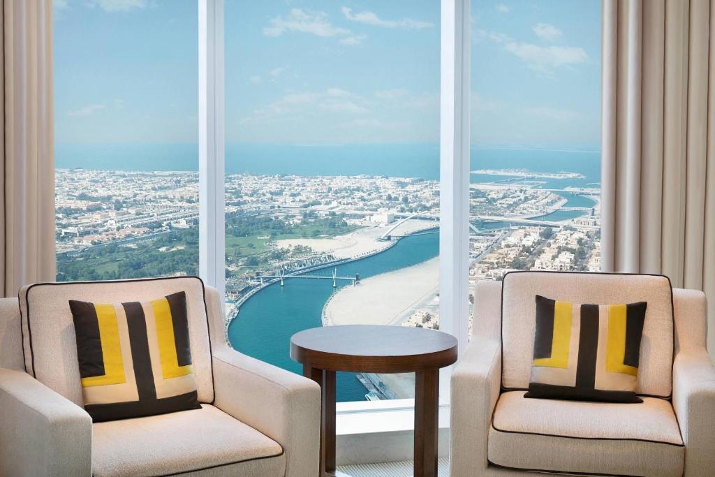two chairs and a table in front of a large window at JW Marriott Marquis Hotel Dubai in Dubai