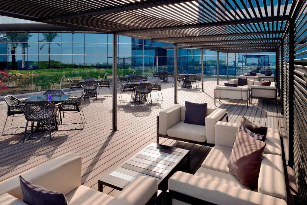 a patio with couches and tables and chairs at JW Marriott Marquis Hotel Dubai in Dubai