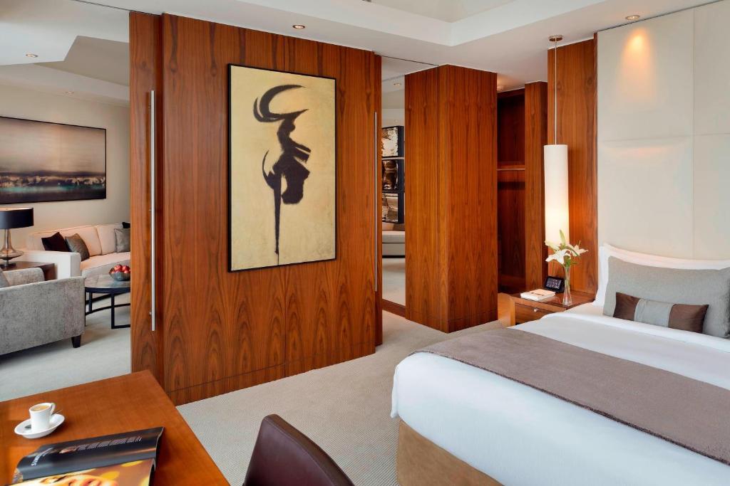 a bedroom with a bed and a desk in a room at JW Marriott Marquis Hotel Dubai in Dubai