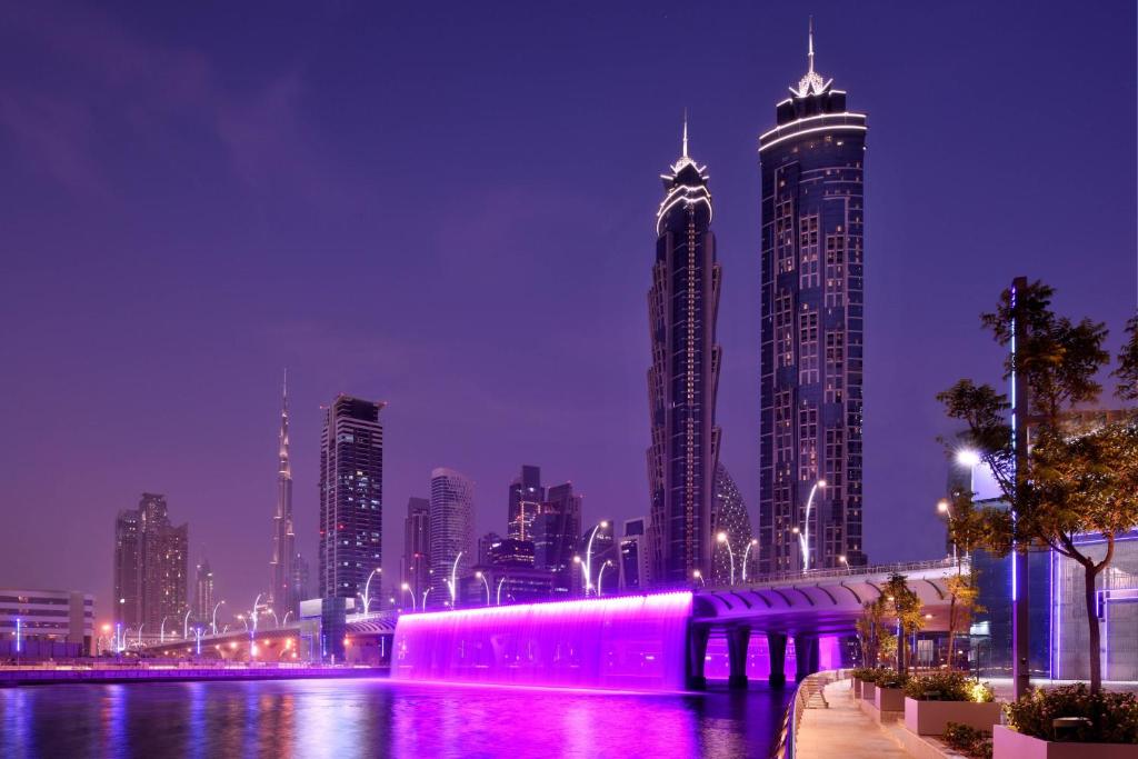 a city skyline at night with tall buildings at JW Marriott Marquis Hotel Dubai in Dubai