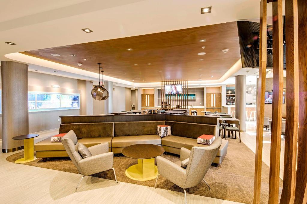 a lobby with a couch and chairs and a bar at SpringHill Suites by Marriott Dayton Vandalia in Murlin Heights