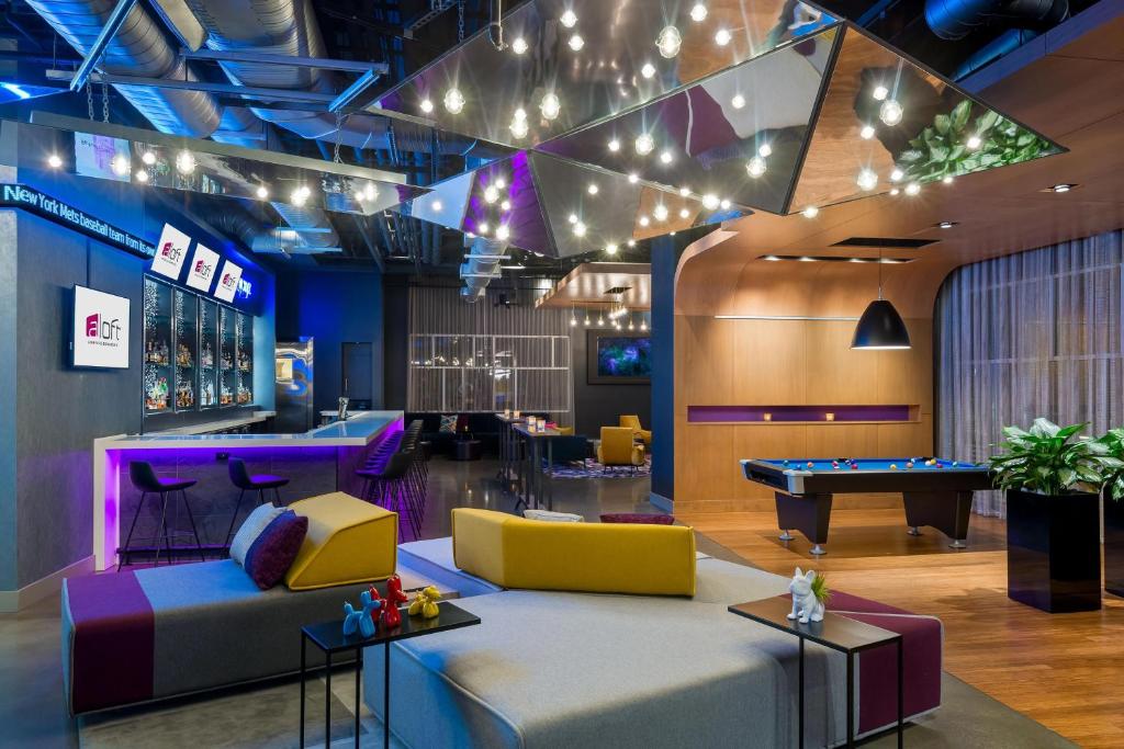 a lobby with couches and a pool table at Aloft Asheville Downtown in Asheville