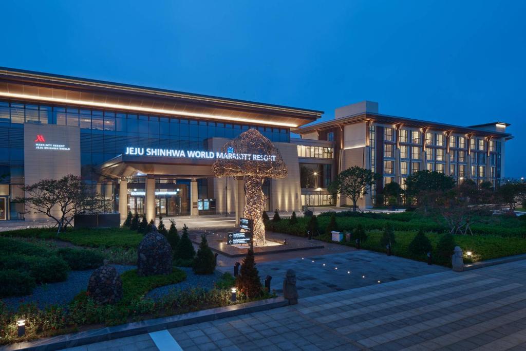 a building with a sign in front of it at Marriott Jeju Shinhwa World Hotel in Seogwipo