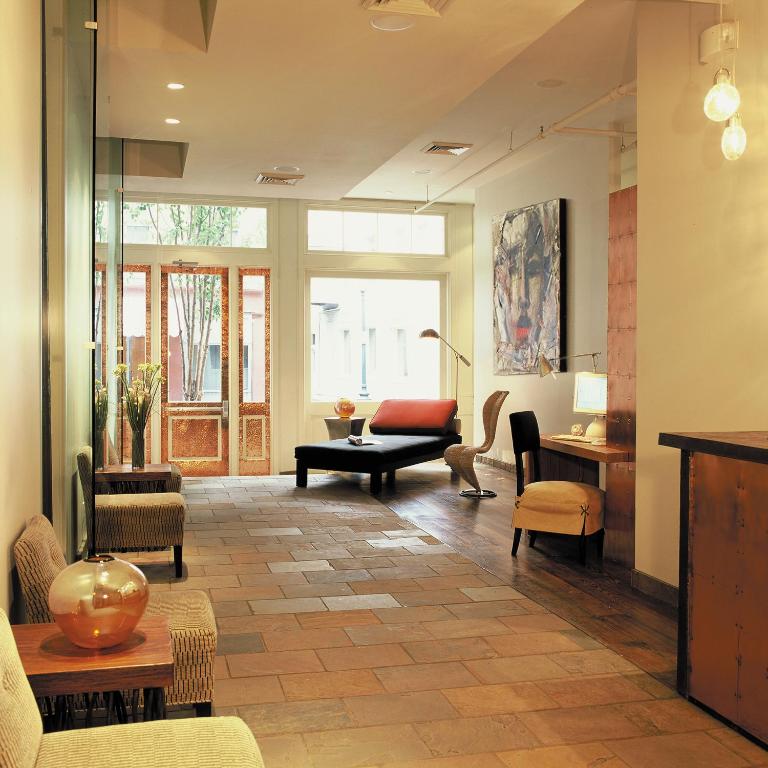 a living room with chairs and a table at Loft 523 in New Orleans