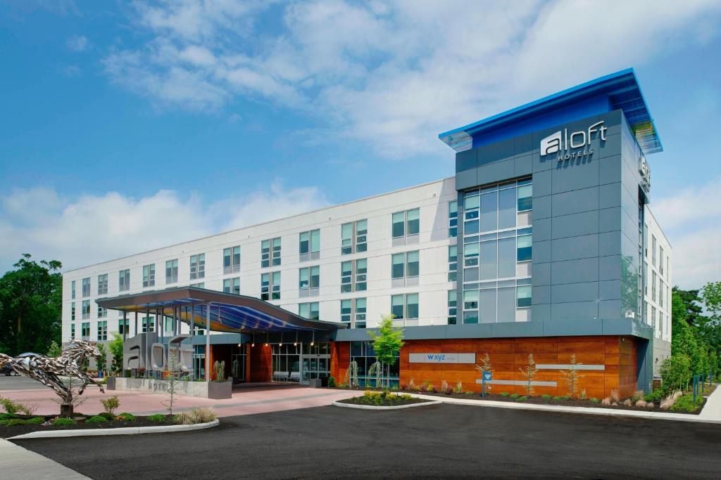 an office building with a sign on the front of it at Aloft Columbus Westerville in Westerville