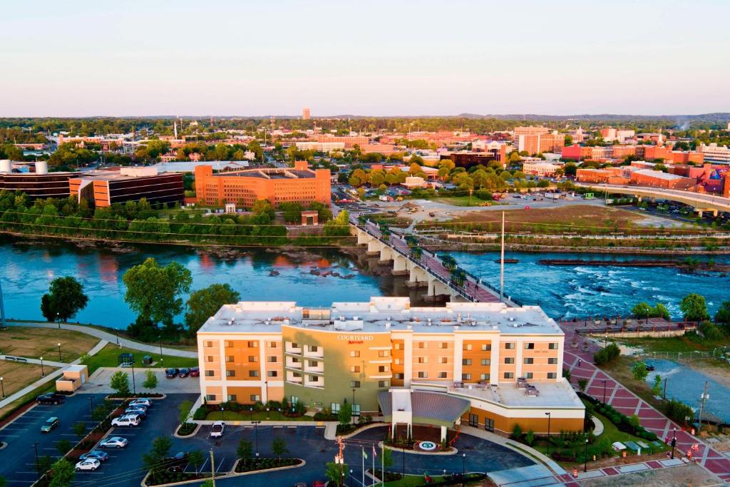 an aerial view of a city with a river and buildings at Courtyard by Marriott Columbus Phenix City in Phenix City