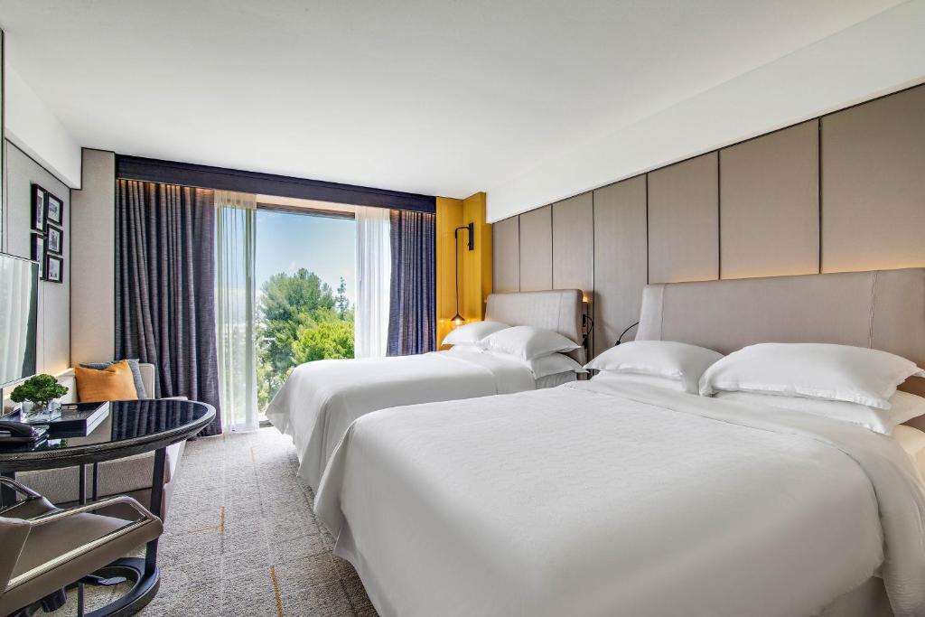 Postel nebo postele na pokoji v ubytování Sheraton Universal