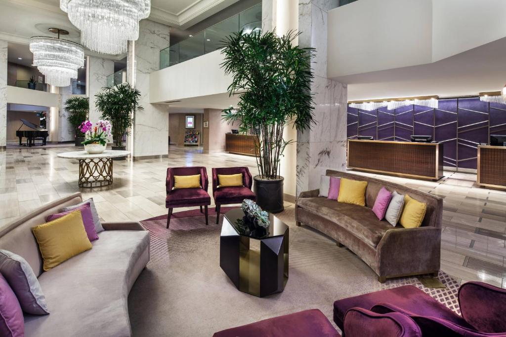 a lobby with couches and chairs in a building at Sheraton Gateway Los Angeles Hotel in Los Angeles