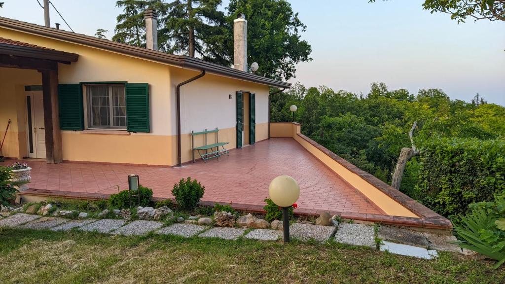 a house with a large patio in front of it at Rocca di Luna a Gemmano in Gemmano