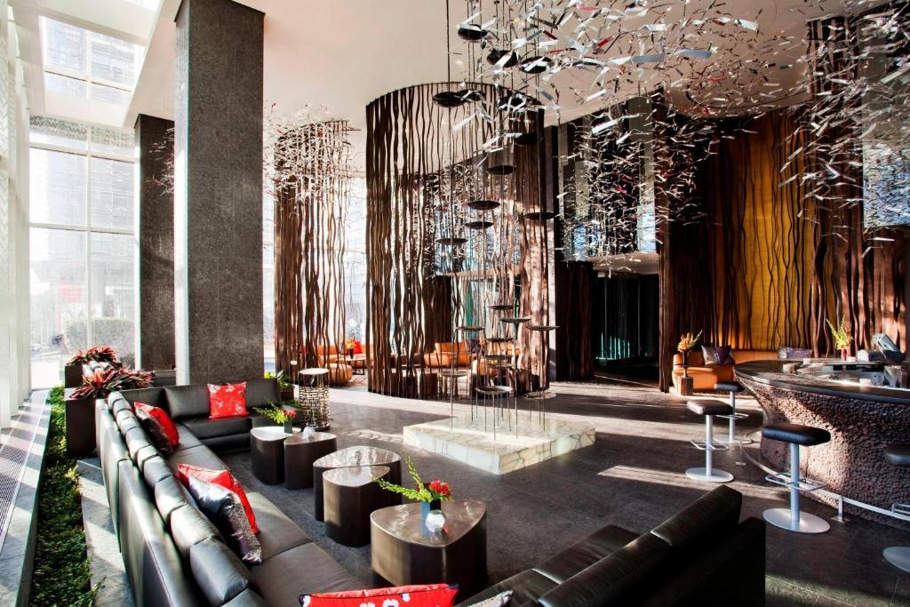 a lobby with a couch and chairs and a table at W Atlanta Downtown in Atlanta