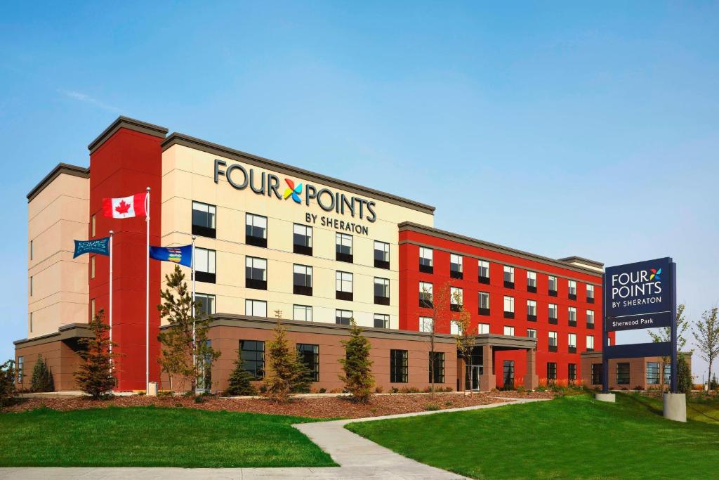 Un cuatro Tom confía en un edificio con una señal. en Four Points by Sheraton Sherwood Park, en Sherwood Park