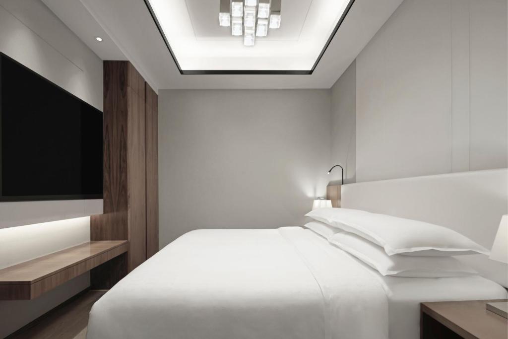 Postel nebo postele na pokoji v ubytování Sheraton Shanghai Chongming Hotel