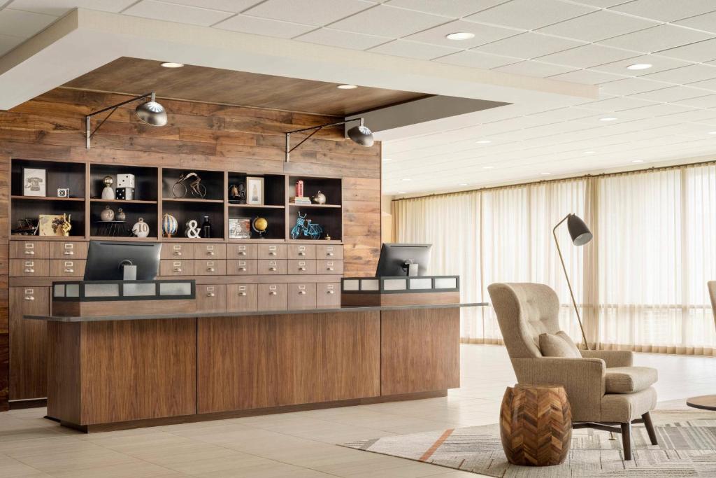 a lobby with a reception desk and a chair at Four Points by Sheraton Myrtle Beach in Myrtle Beach