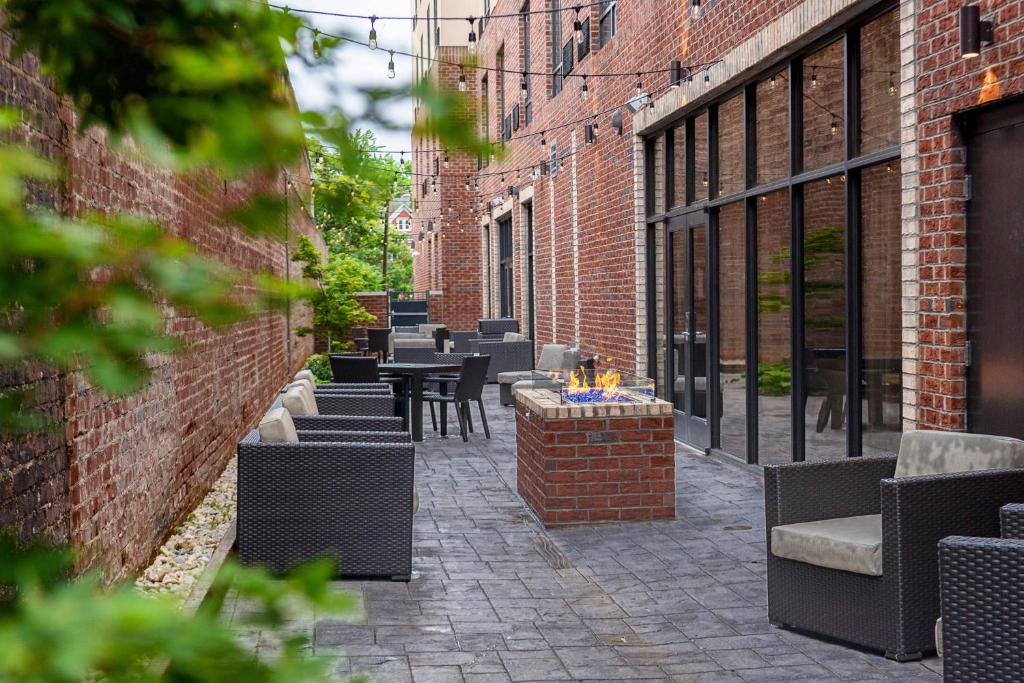 a patio with tables and chairs on a brick building at Courtyard Winston-Salem Downtown in Winston-Salem