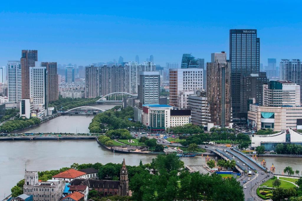 a view of a city with a river and buildings at The Westin Ningbo in Ningbo