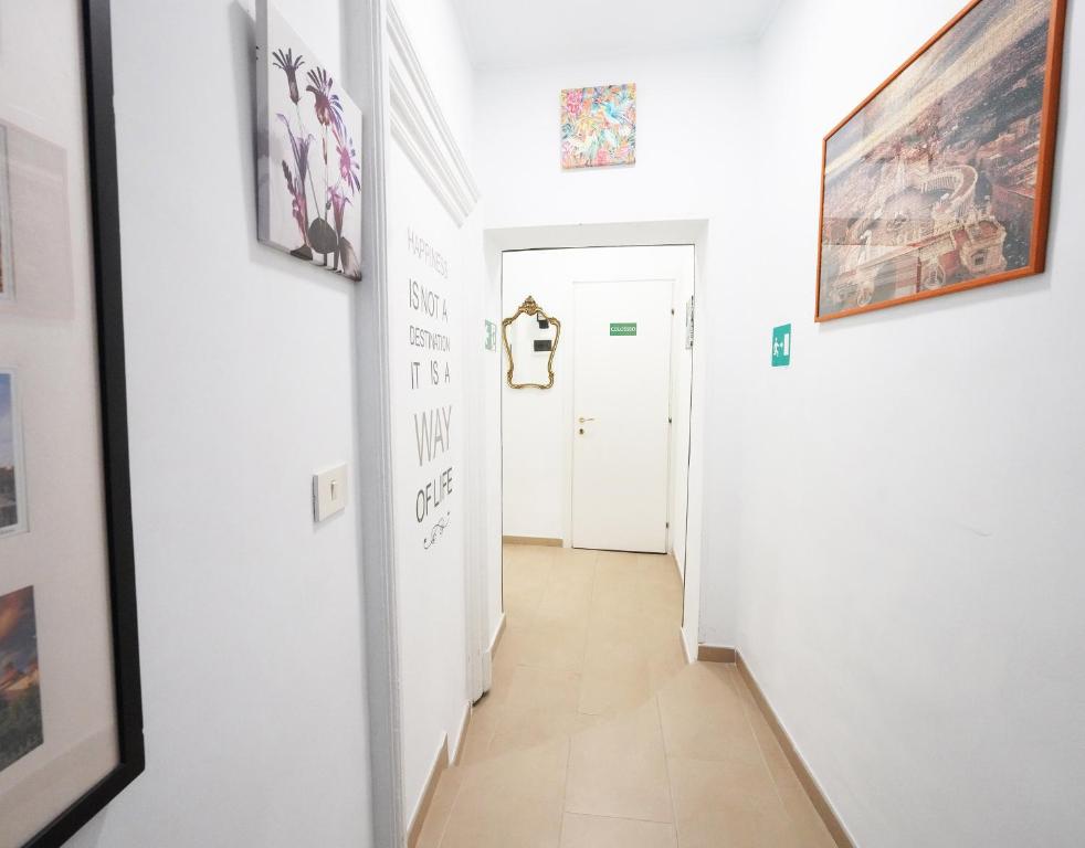 a hallway with art on the walls of a room at Key Rome Center in Rome