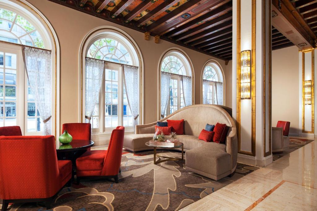 a living room with a couch and chairs and windows at The Westin San Jose in San Jose