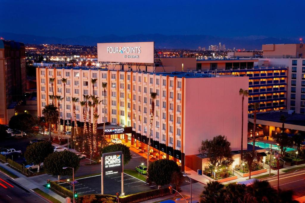 a large building with a sign on top of it at Four Points by Sheraton Los Angeles International Airport in Los Angeles