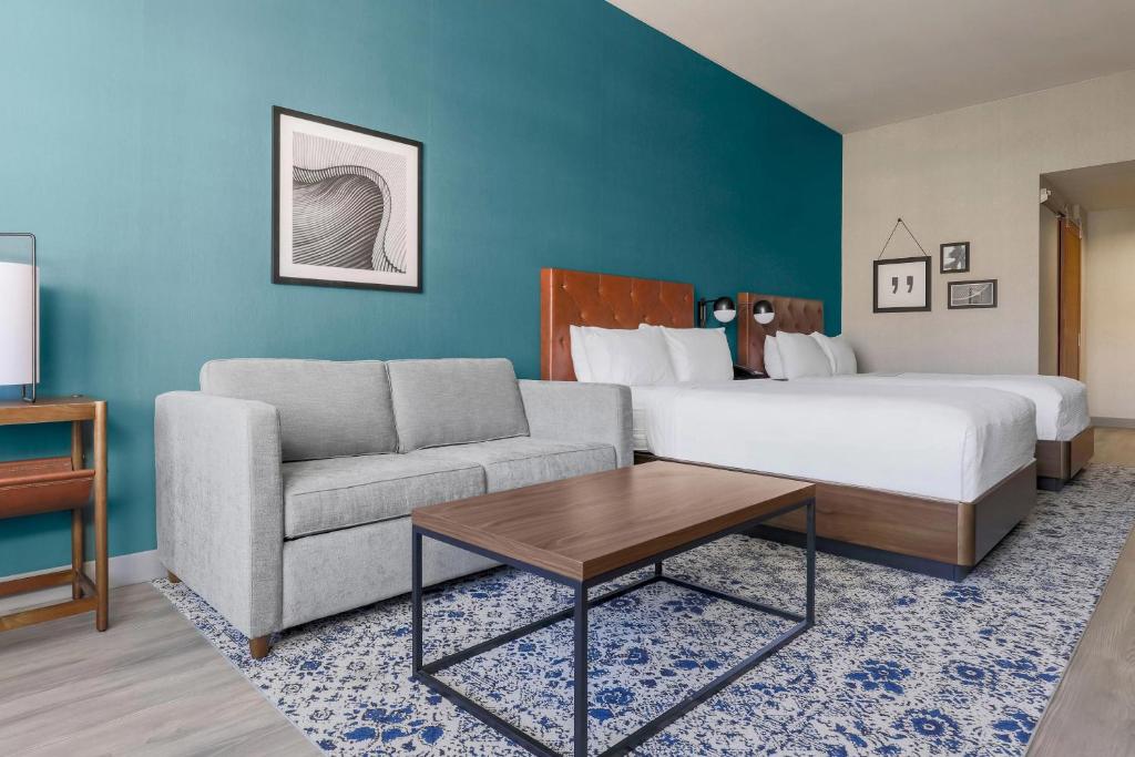 a hotel room with a bed and a couch at Four Points by Sheraton, Ontario-Rancho Cucamonga in Rancho Cucamonga
