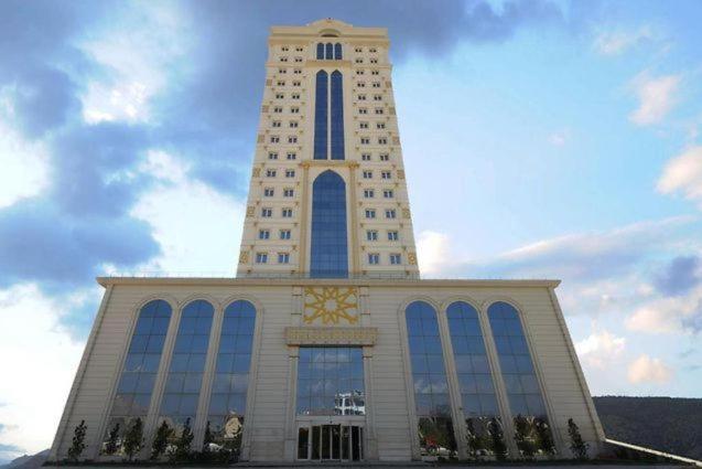a large building with a tower with a clock on it at Crixus Duhok in Duhok