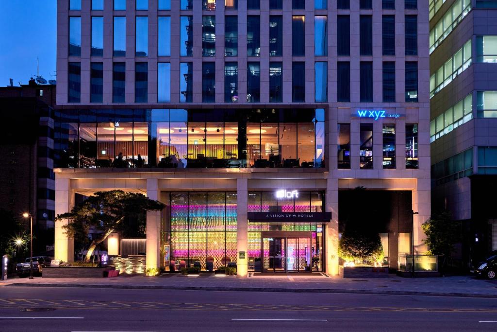a large building with a lot of windows at night at Aloft Seoul Gangnam in Seoul
