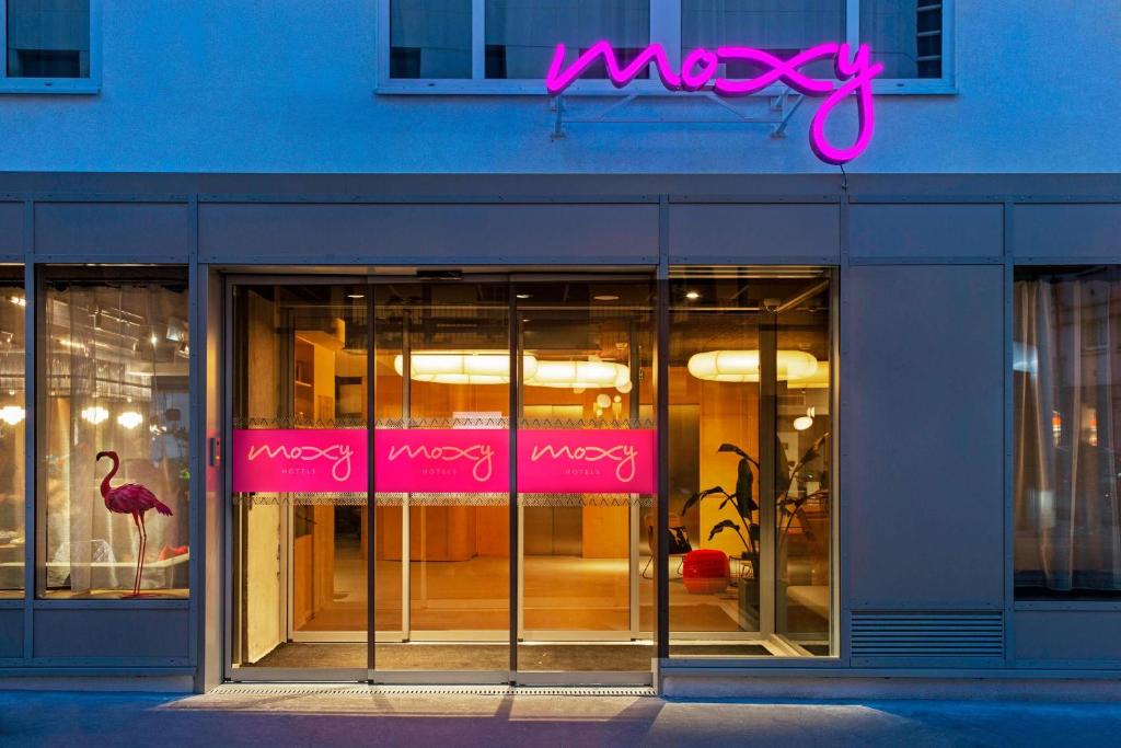 a store front with a pink neon sign on it at Moxy Paris Bastille in Paris