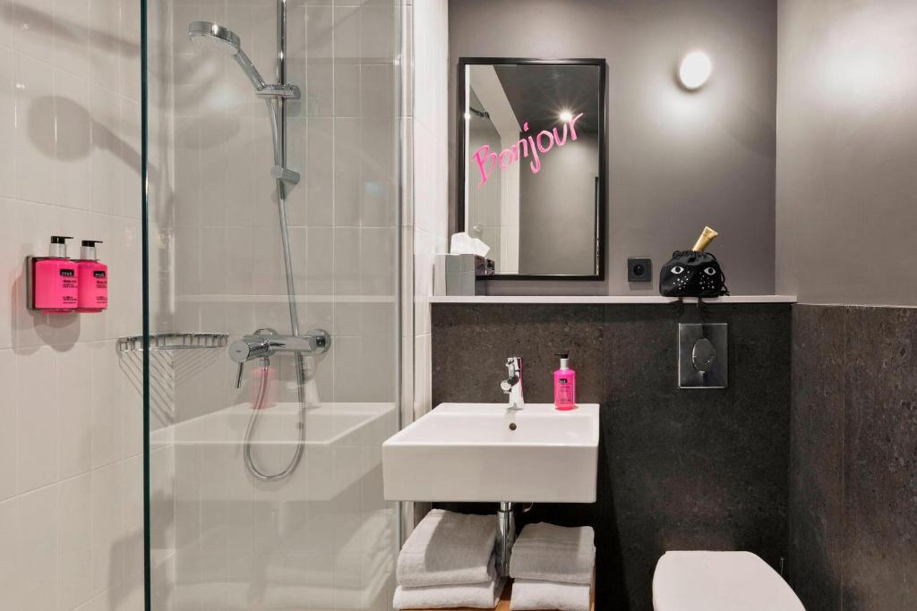 a bathroom with a shower and a sink and a shower at Moxy Paris Bastille in Paris