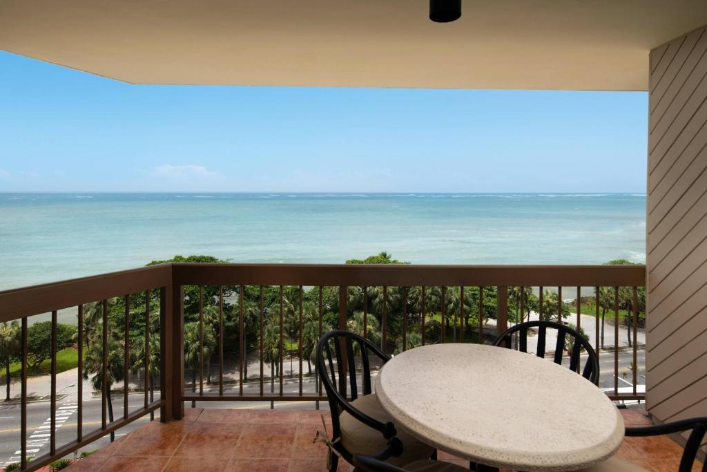 a balcony with a table and chairs and the ocean at Sheraton Santo Domingo in Santo Domingo