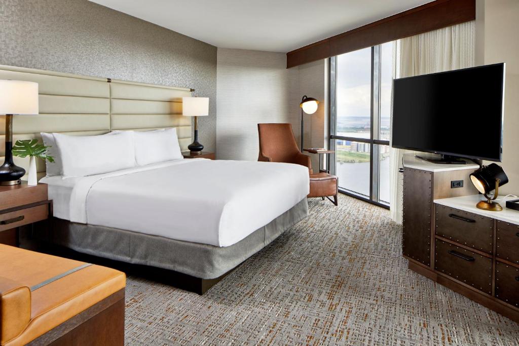 a hotel room with a bed and a flat screen tv at Renaissance Mobile Riverview Plaza Hotel in Mobile