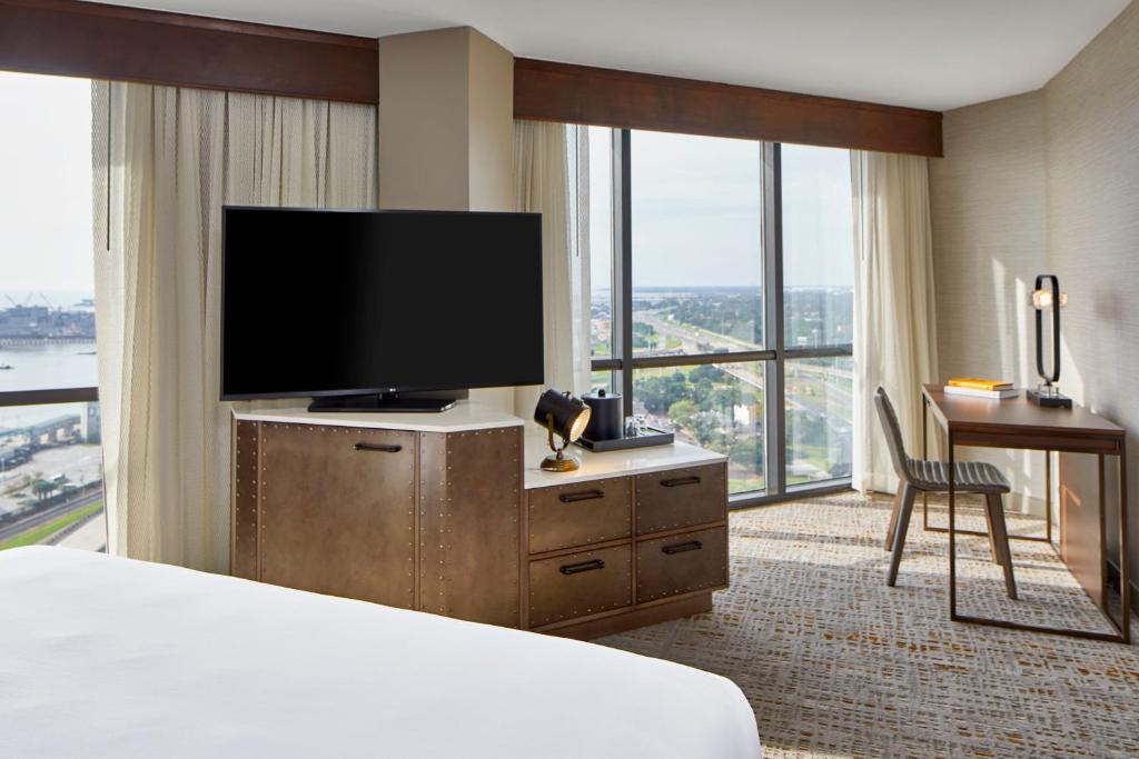 a hotel room with a bed and a flat screen tv at Renaissance Mobile Riverview Plaza Hotel in Mobile