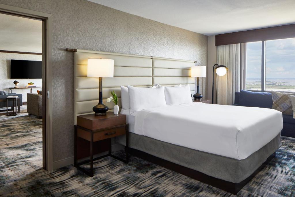 a hotel room with a large bed and a large window at Renaissance Mobile Riverview Plaza Hotel in Mobile