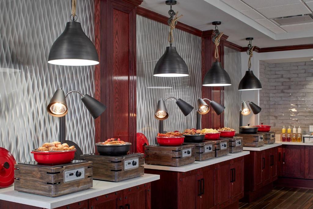 a buffet line with bowls of food and lights at Renaissance Mobile Riverview Plaza Hotel in Mobile