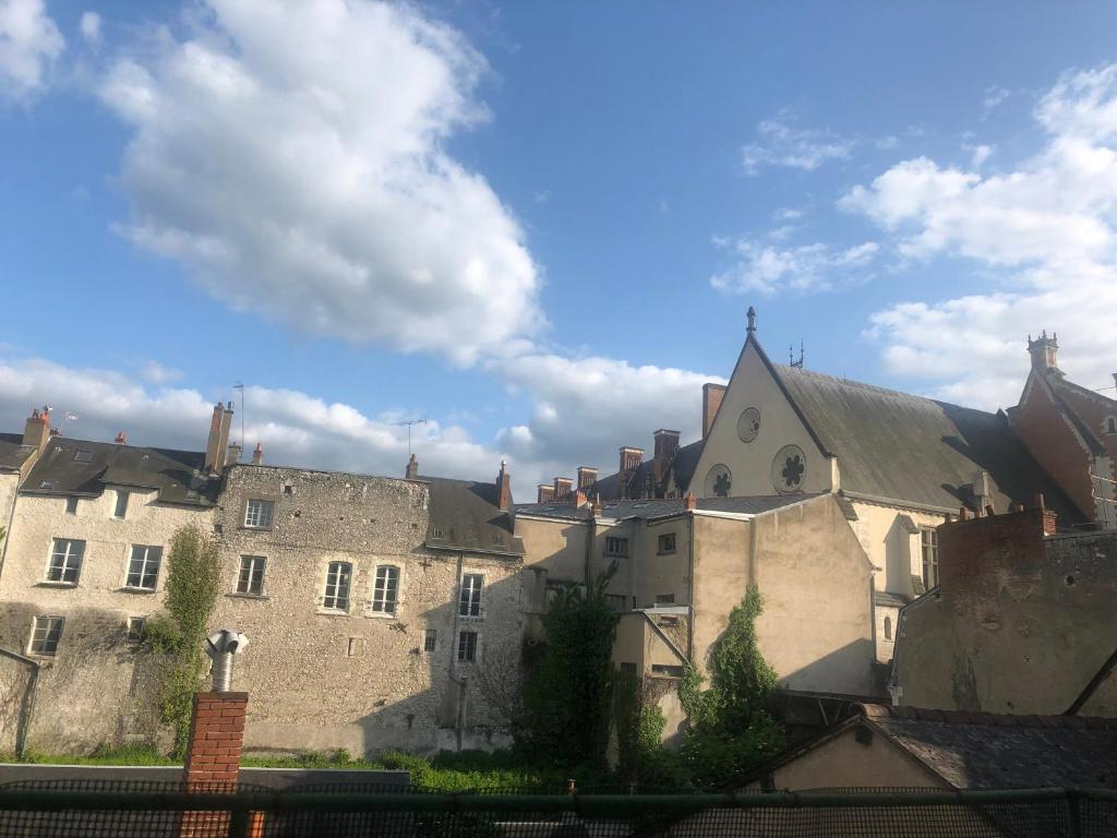 a group of buildings and a blue sky with clouds at Hypercentre - Coté Chateau in Blois