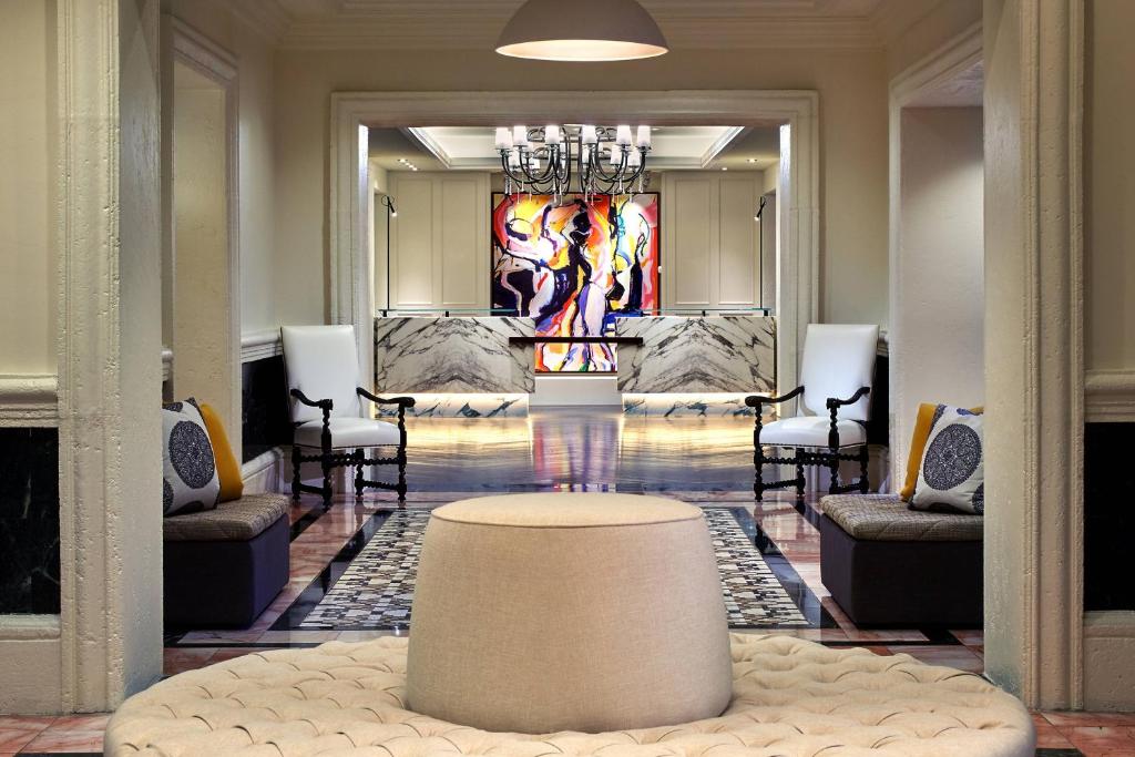 a lobby with a table in the middle of a room at Hotel Colonnade Coral Gables, Autograph Collection in Miami