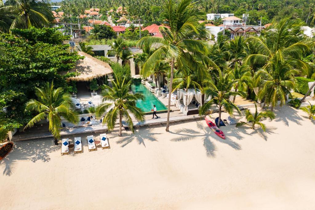 an aerial view of a beach with palm trees and a resort at ODYSSEY - Luxury Beachfront Mansion - in Koh Samui