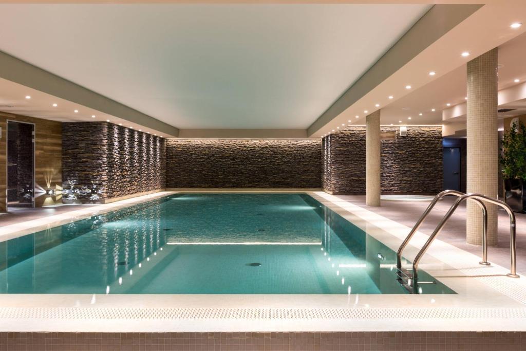 a pool in a hotel with a swimming pool at AC Hotel by Marriott Wroclaw in Wrocław