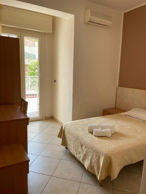 Postel nebo postele na pokoji v ubytování Hotel Favorita