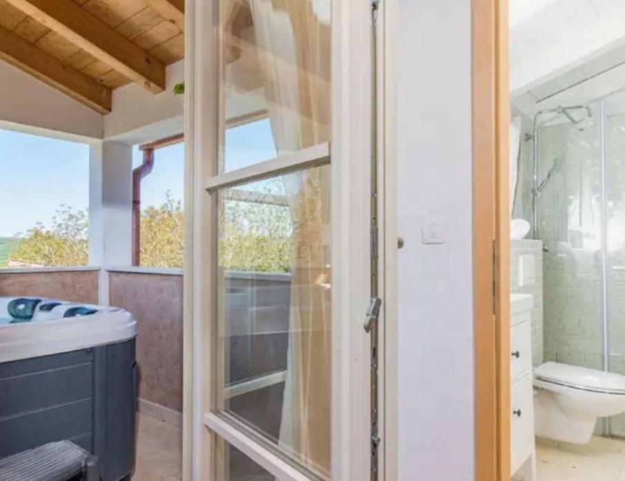 een badkamer met een douche, een toilet en een wastafel bij Wellness House Oliva with heated salt water Pool, Sauna & Jakuzzi in Labin