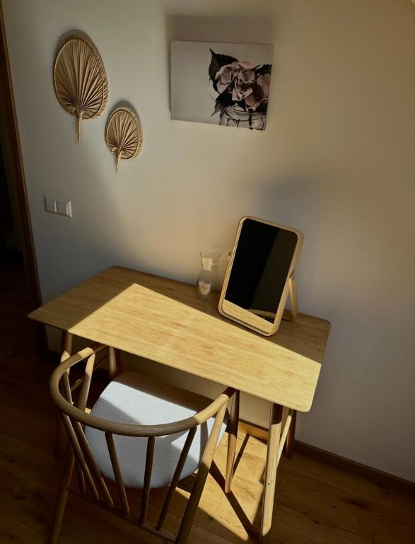a wooden desk with a computer on top of it at Rugio namai-Rye house in Palanga