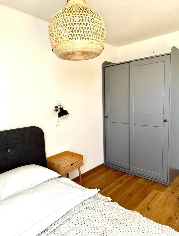 a bedroom with a bed and a large closet at Rugio namai-Rye house in Palanga
