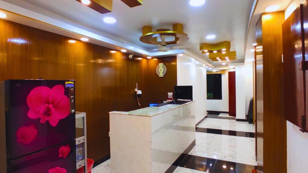 a lobby with a counter with a flower painted on it at Hotel Muna Dhanmondi Six Floor in Dhaka