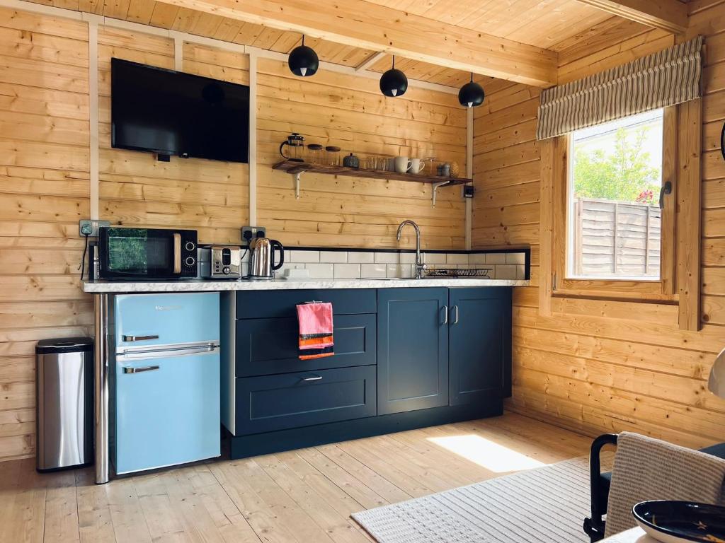 a kitchen with a sink and a counter top at Log Cabin in Bideford