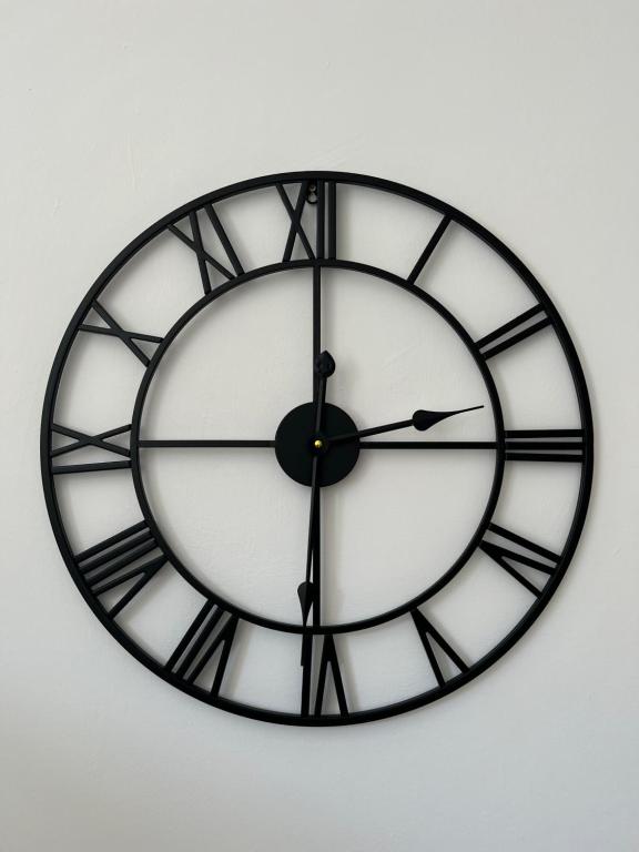 a large black and white clock on a wall at Large 3 bed - 10 mins to centre in Liverpool