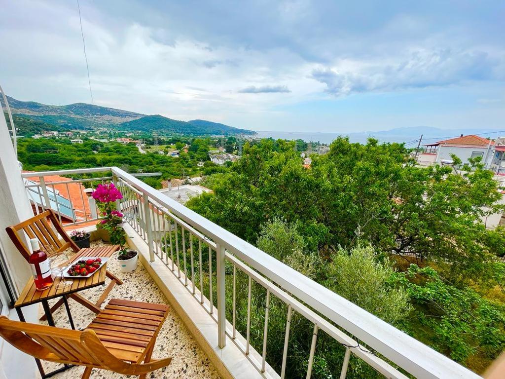 a balcony with two chairs and a table at Rose House in Kavála
